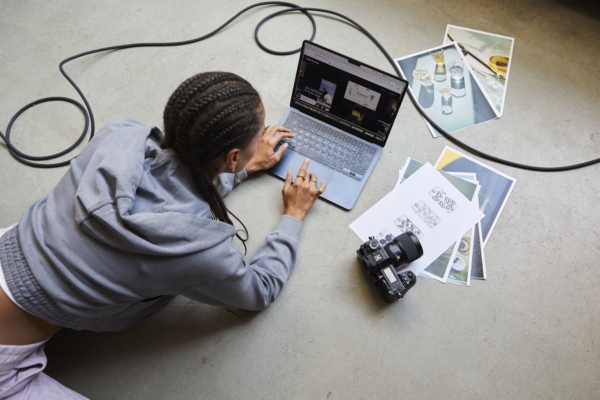 Image Of Person Working On Laptop Surrounding By Creative Assets Camera